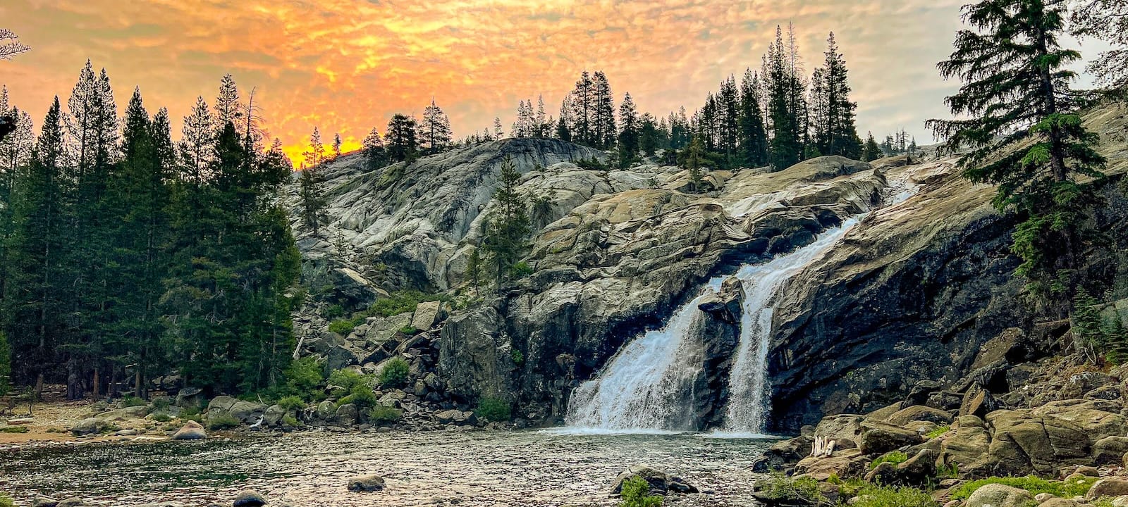 A beautiful sunset over the waterfall at Glen Aulin