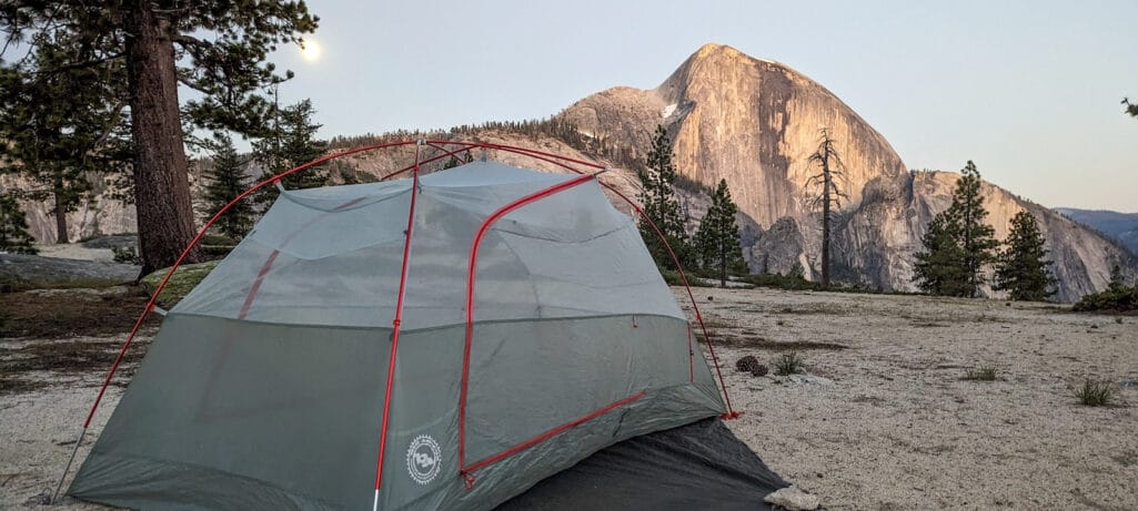 A tent with Half Dome in the background