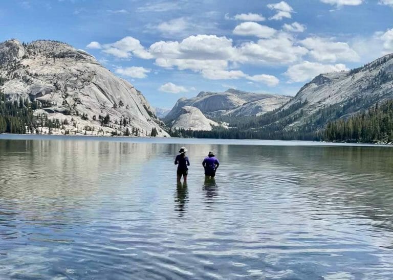 wading in an alpine lake on one of our Yosemite Guided Backpacking Trips