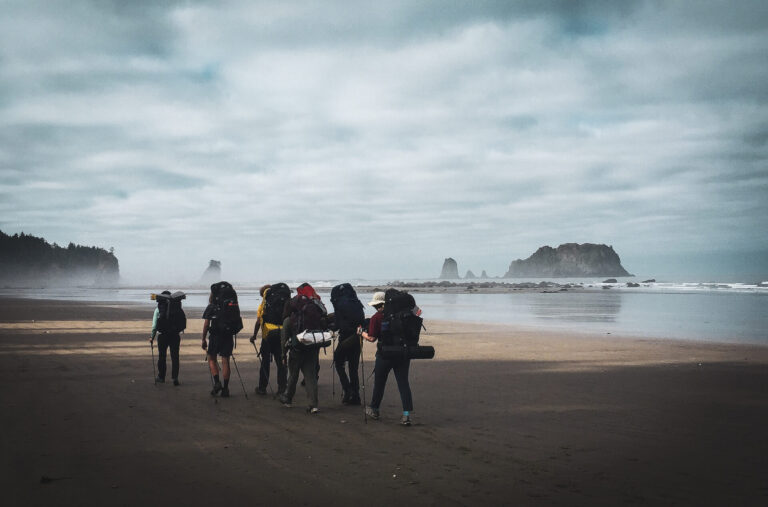 Backpackers walking on the beach