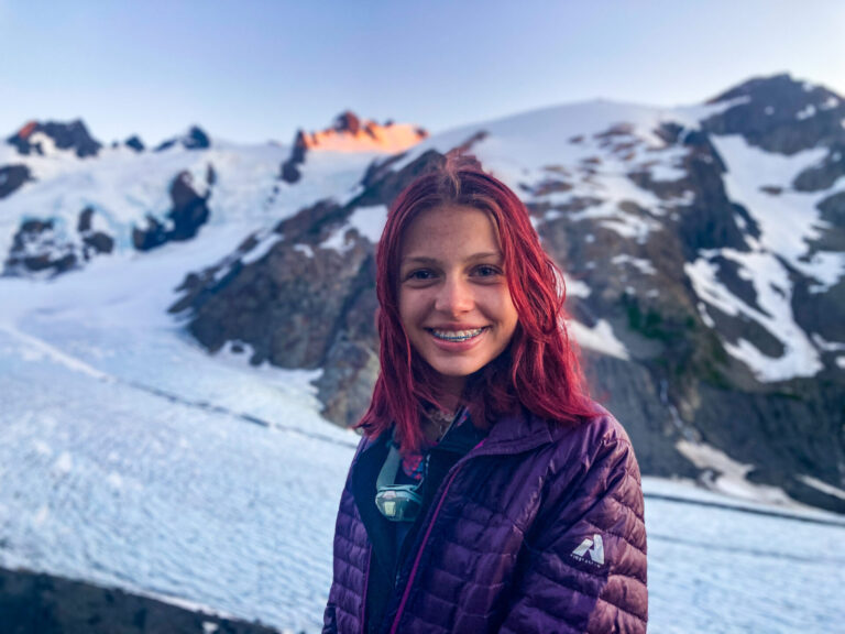 Girl smiling in front of Blue Glacier