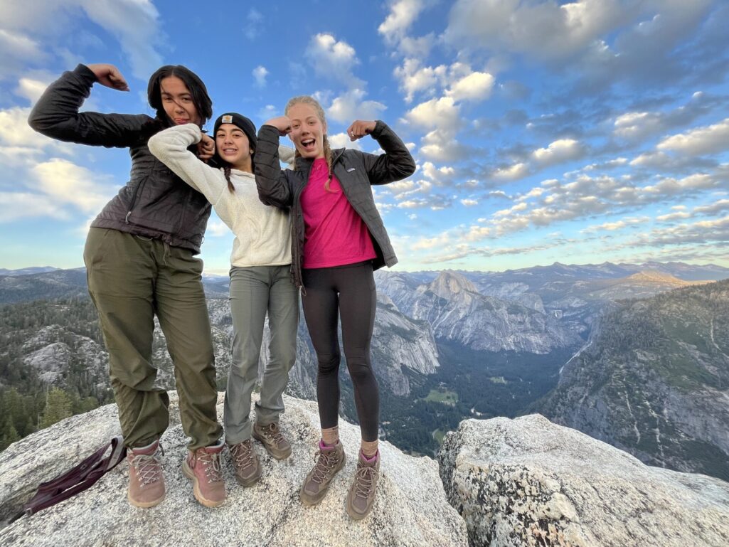 Girls flexing in front of a great view