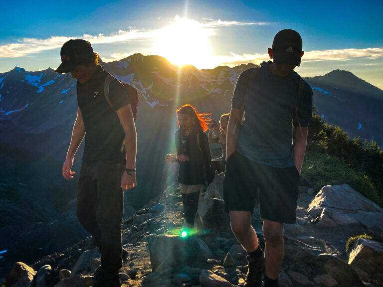 Hikers in fading sunlight in front of Mt. Olympus