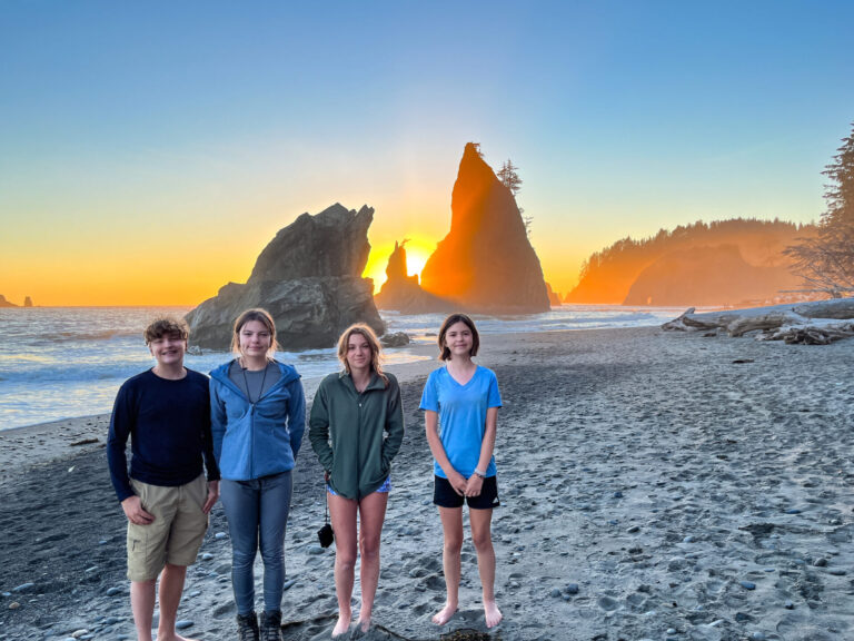 Kids in front of sea stacks for sunset