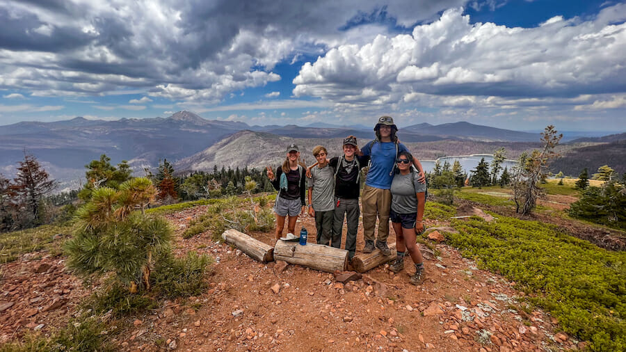 13-Day trip posing in front of grand scenery.