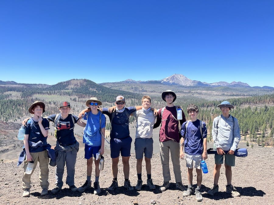 Boys trip in Lassen posing in front of Lassen Peak.