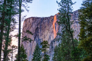 Horsetail Fall on El Capitan glowing orange with the sunset.