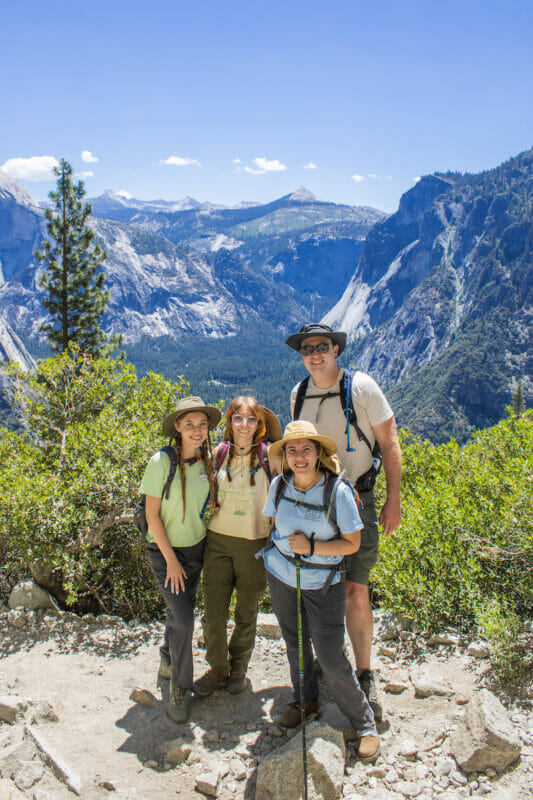 Family posing in front of a good view on the Upper Yosemite Falls Trail.