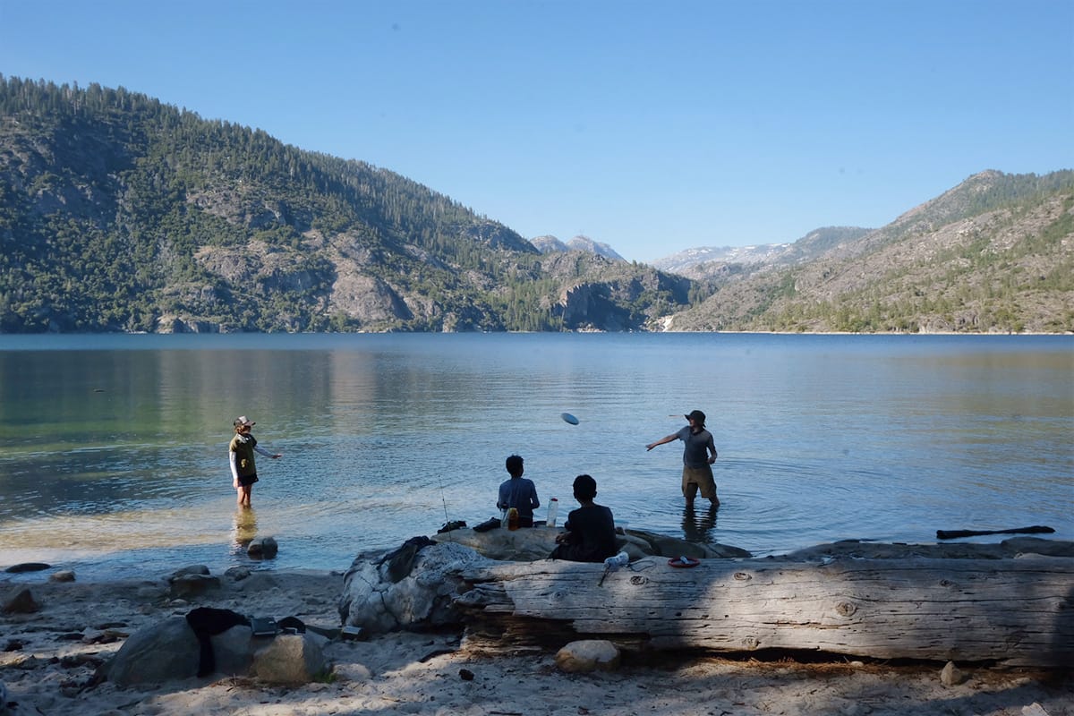 Campers play games on the shore of Eleanor Lake in Hetch Hetchy