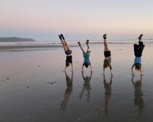 Kids doing handstands on the beach in Olympic National Park.