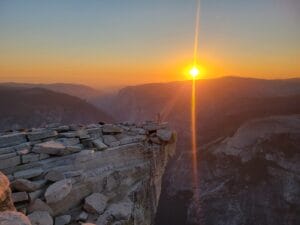 The sun setting on top of Half Dome.