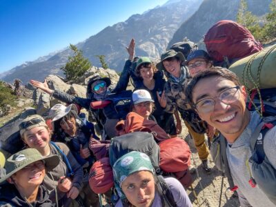 A group shot of a group of backpacking teens.