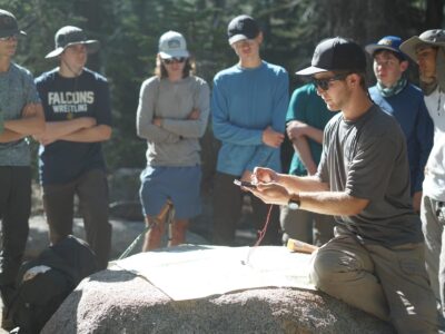 An educator teaching teens Map & Compass