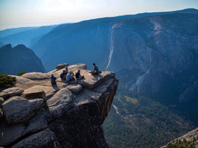 An educator teaching a group of teens on top of Taft Point