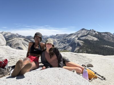 Two girls smiling on top of Half Dome