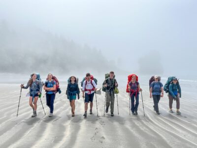 A group of teens backpacking in the fog in Olympic National Park