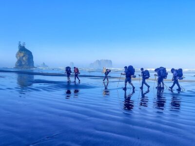 A group of teens backpacking along the coast in Olympic National Park
