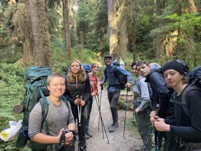 A group of teens backpacking in the forest of Olympic National Park