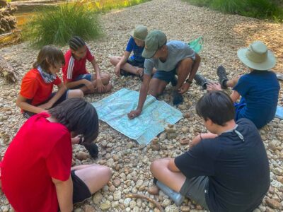Studying the map during one of our outdoor summer camps for kids