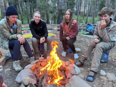 Teens in front of a campfire