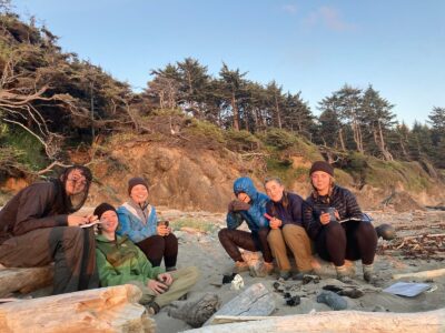 Teen backpackers watching the sunset in Olympic National Park
