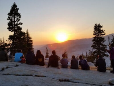 teens enjoying the sunset during on of our teen wilderness training trips
