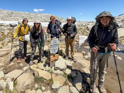 A group of teens at the Inyo National Forest sign