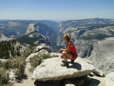 a young women takes in the view during our girls summer camp in Yosemite