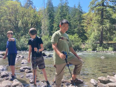 Campers playing a stream on one of our backpacking summer camps