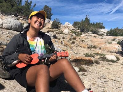 A youth playing music during one of our summer camps in Yosemite